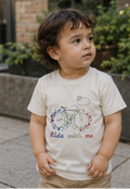 Autistic toddler wearing cream Ride With Me autism awareness T-shirt in a calm urban park, sensory-friendly clothing for neurodivergent children.
A young autistic toddler wearing the Kids in Rainbows Ride With Me sensory-friendly T-shirt in a peaceful outdoor setting. Designed to celebrate neurodiversity, inclusion, autism acceptance, and different ways of experiencing the world. Soft cotton clothing for autistic children, sensory-sensitive kids, and neurodivergent families.